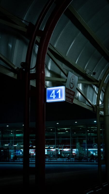 A dimly lit terminal sign '41' at Bursa Airport, Türkiye, captured during nighttime.